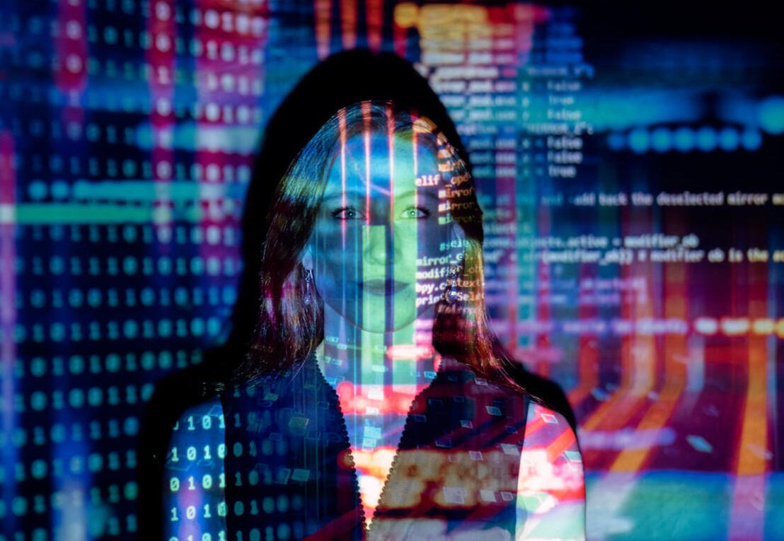Writing for tech companies Girl standing in front of colorful projection of lines of code